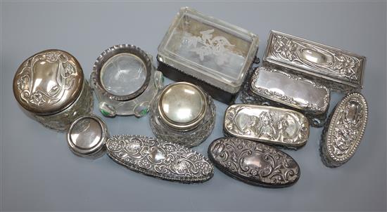 Eleven assorted Edwardian and later silver mounted glass toilet jars including Art Nouveau.